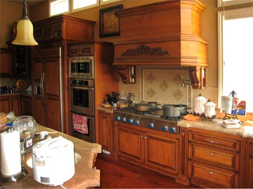 carved range hood, frig cabinets